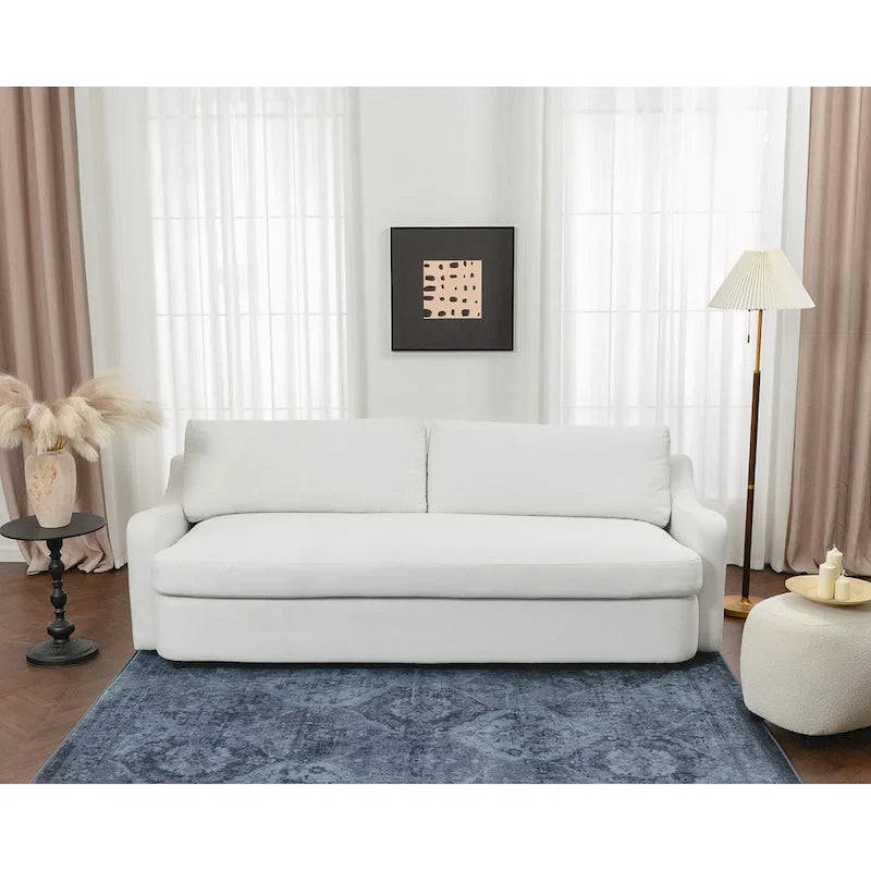 Sofá de tres plazas tapizado en lino con asientos profundos y cojines reversibles